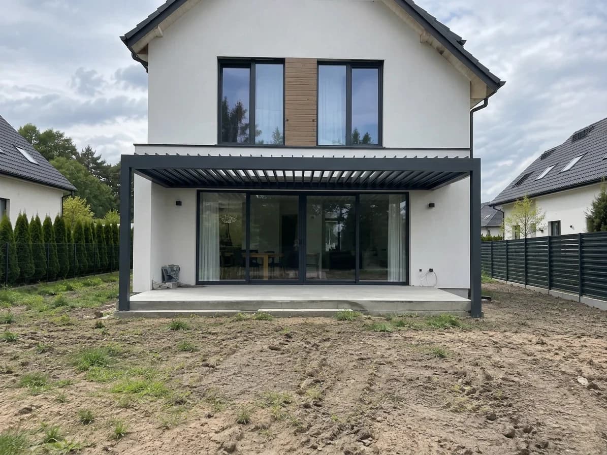 Existing rear terrace with a bare sand yard before any landscaping